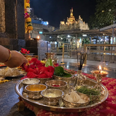 Sixteen offerings in silver bowls with modaks, durva and red hibiscus