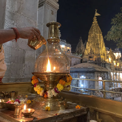 A large brass akhand jyoti lamp with a steady flame