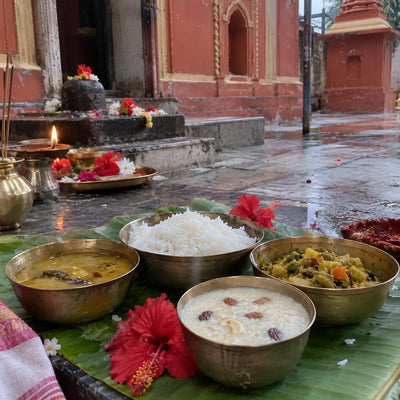 Bengali anna bhog of rice, dal, labra and payesh on a banana leaf