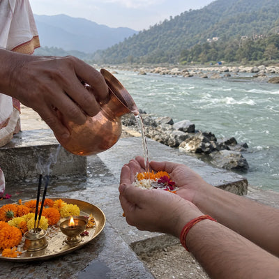 Gangajal poured into cupped hands for a sankalp at the ghat