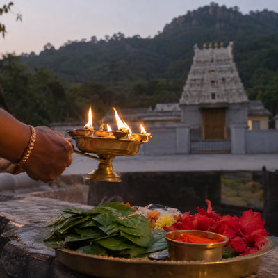 Hanuman Abhishekam: a brass harathi lamp before betel leaves and sindoor