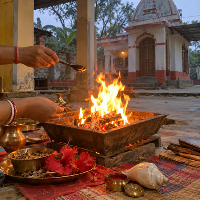Havan fire with red hibiscus, a conch and sindoor