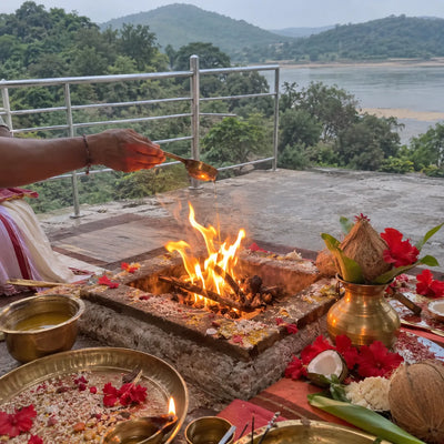 Homa fire with red hibiscus, a coconut and a kalash