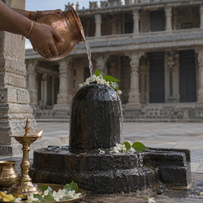 Kumara Bhimeswara Abhishekam: water poured over a Shivling with jasmine and bilva leaves