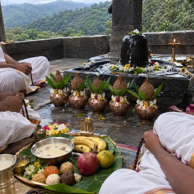Five kalashes, rudraksha malas and naivedya before a Shivling