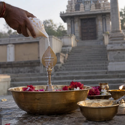 Moolavar Abhishekam: milk poured from a conch over a brass vel