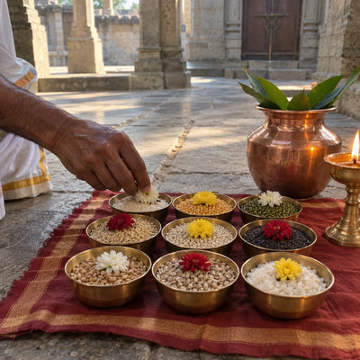 Nine brass bowls of different grains arranged in a square for a Navgraha puja