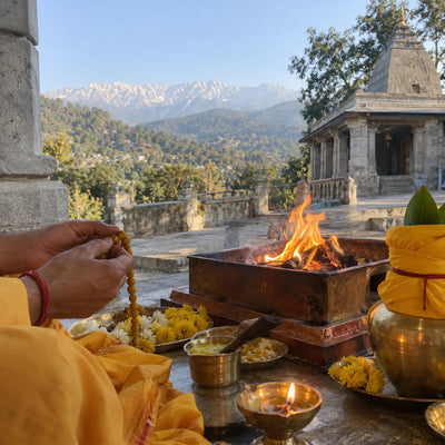 Turmeric mala being counted beside a havan kund and a yellow kalash