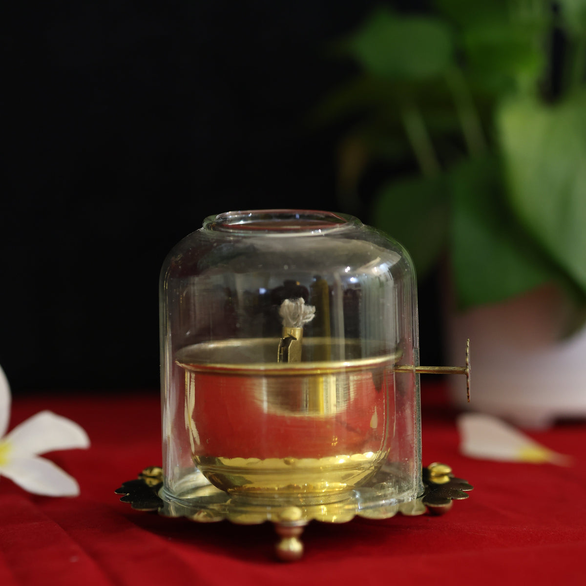 Lit brass oil diya with a glass chimney for Narak Chaturdashi 2026, the Yama lamp of Choti Diwali