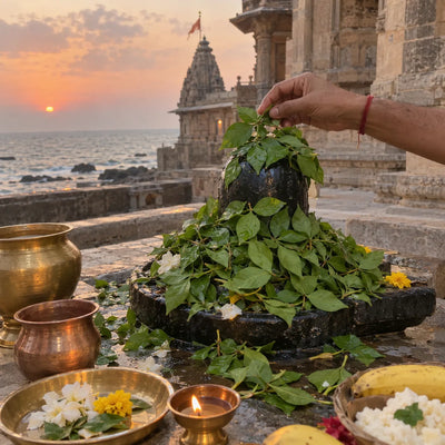 A Shivling under a mound of bilva leaves, seaside temple at sunset