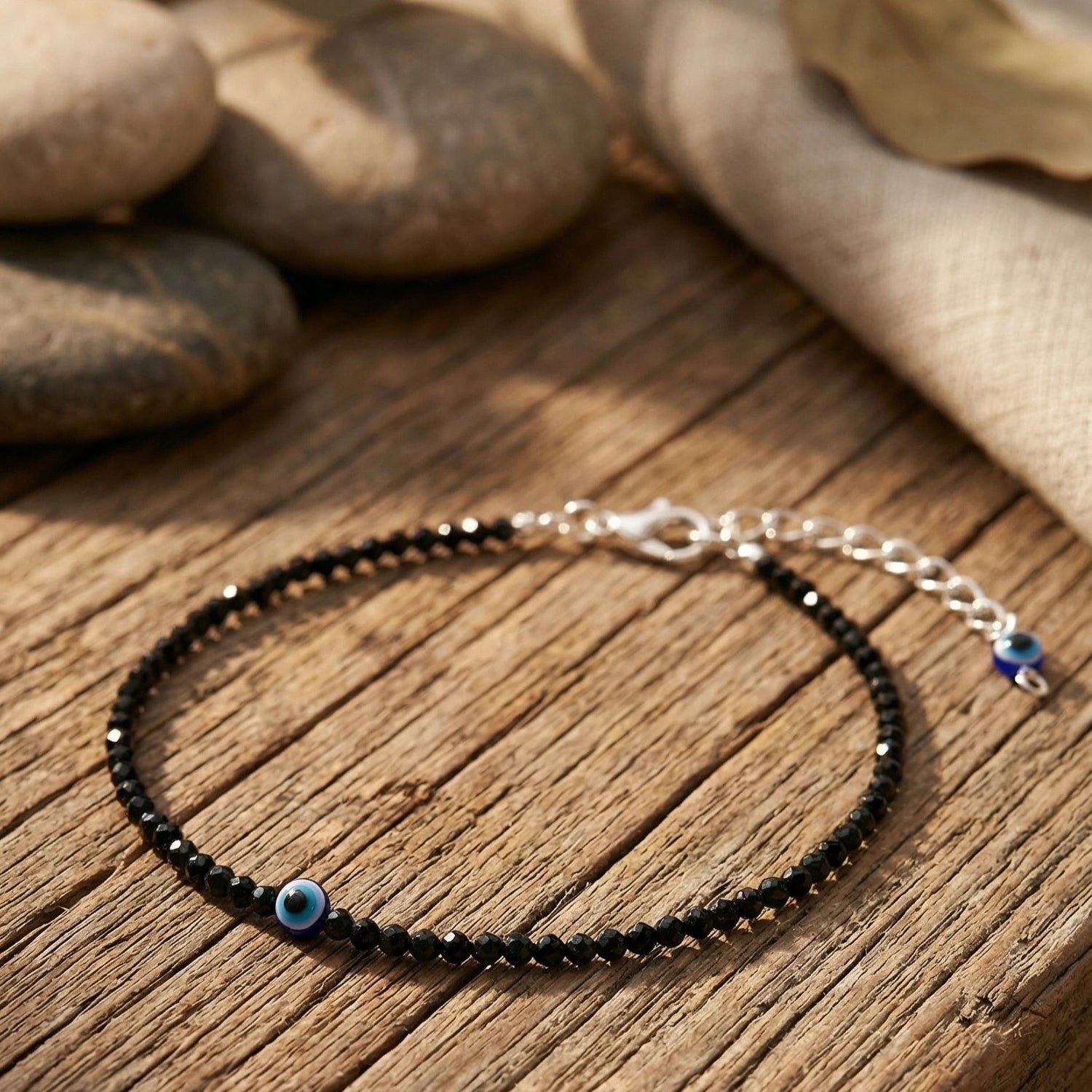 evil eye anklet on a wooden surface