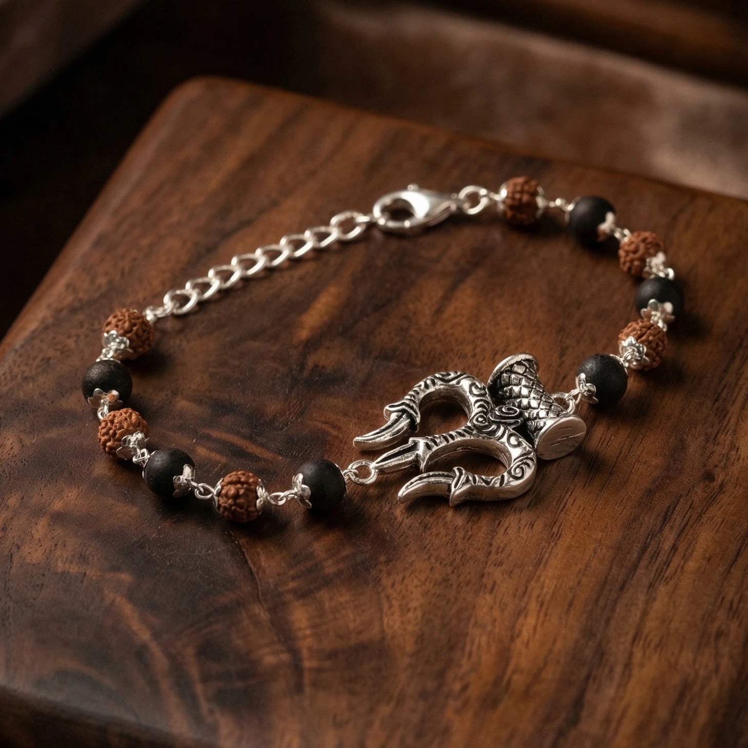 Silver cap Rudraksha karungali Bracelet With Trishul Damroo