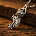 Hanuman Gada pendant on a wooden surface