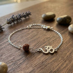 Rudraksha Bracelet Silver on a wooden surface