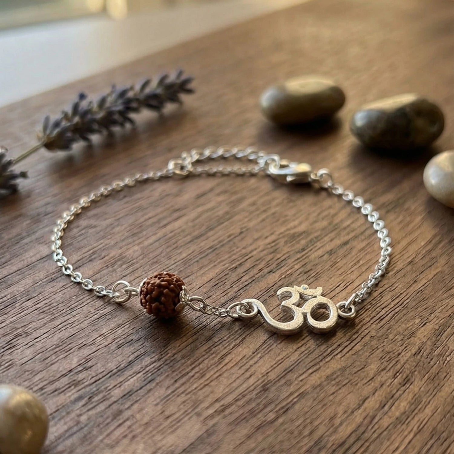 Rudraksha Bracelet Silver on a wooden surface