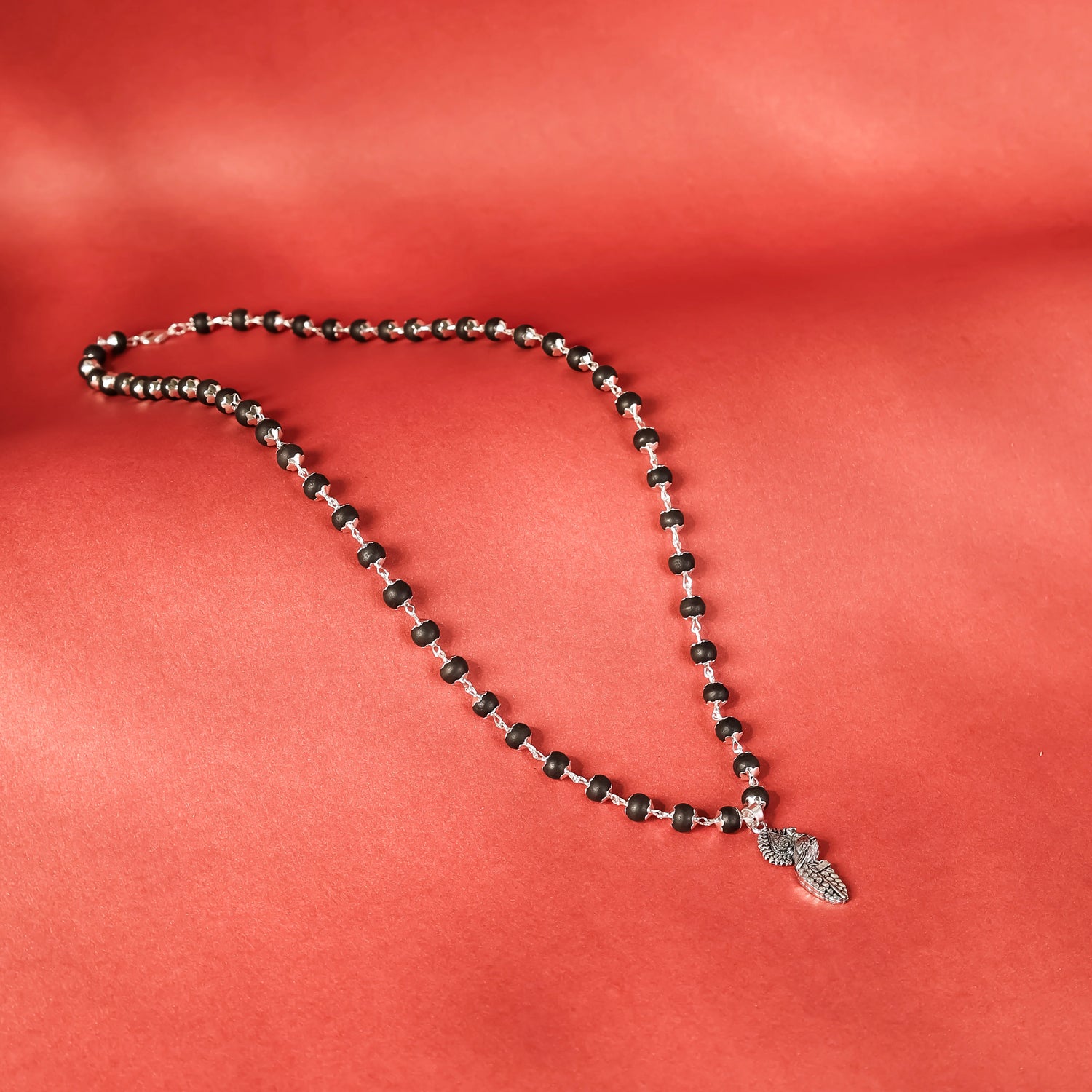 Silver Cap Karungali Mala with Vel Peacock Pendant