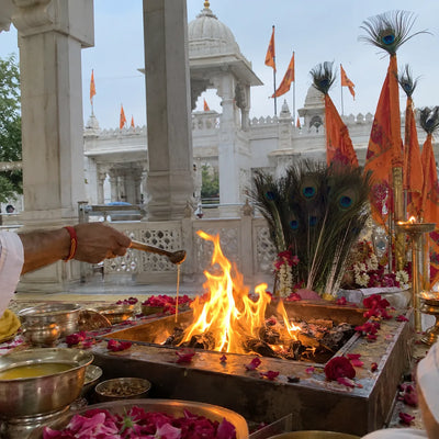 Havan fire with peacock feathers and saffron nishan flags