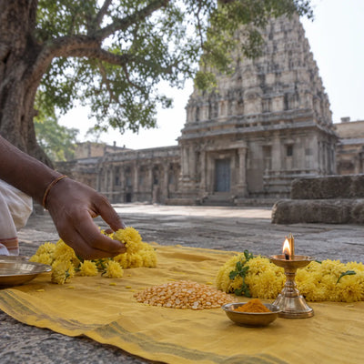Guru (Jupiter) Archana: yellow flowers and Bengal gram on a yellow cloth for Guru archana