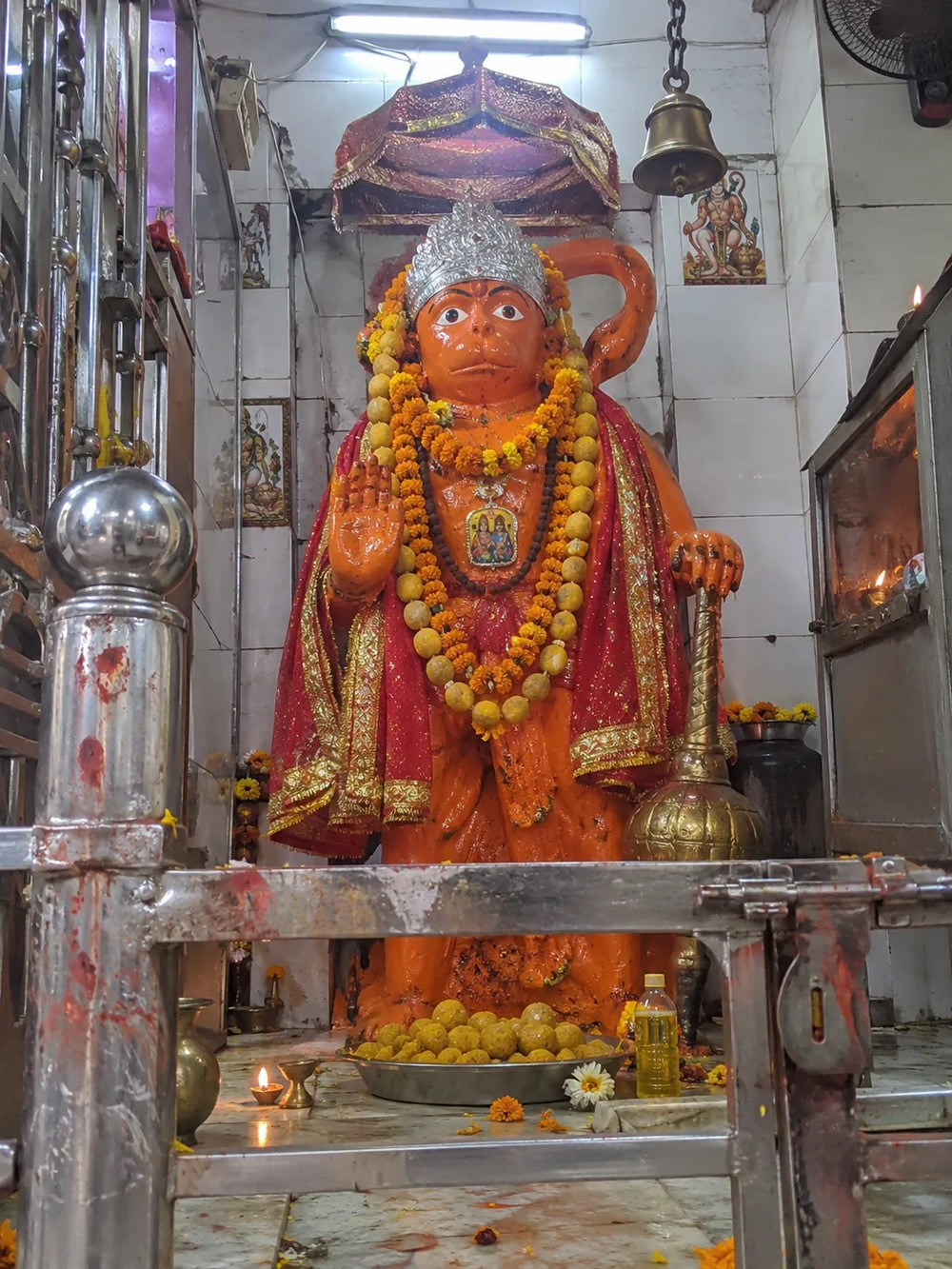 Rog Mukti Hanuman Puja: Hanuman Ji's shrine in sindoor with marigold garlands and boondi laddoos