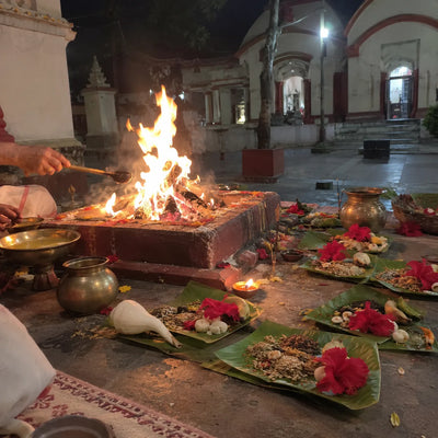 Havan fire at night with seven offering sets on banana leaves