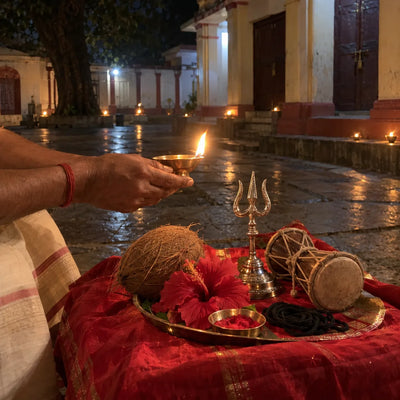 Oil lamp, trishul and damru with red hibiscus for Kaal Bhairav puja