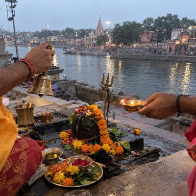 Two priests' hands with a bell and an oil lamp for Kal Bhairav puja
