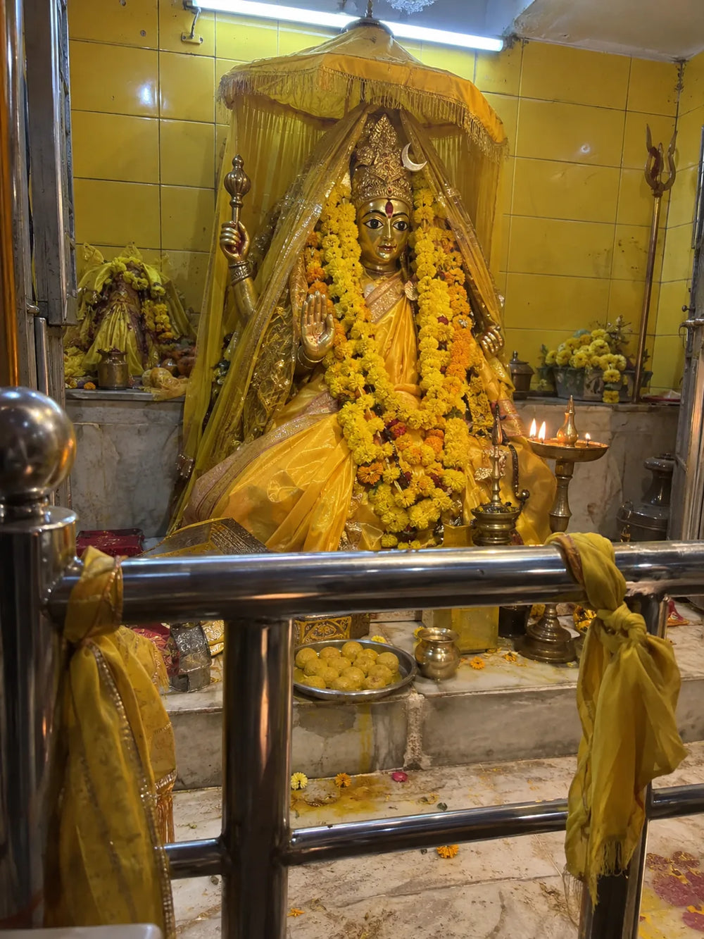 Maa Baglamukhi Puja: Maa Baglamukhi, Pitambara, dressed in yellow with marigold garlands
