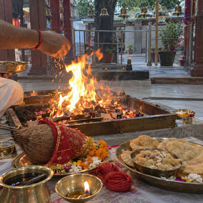 Havan fire with a kalava thread, a chunri-wrapped coconut and bhog