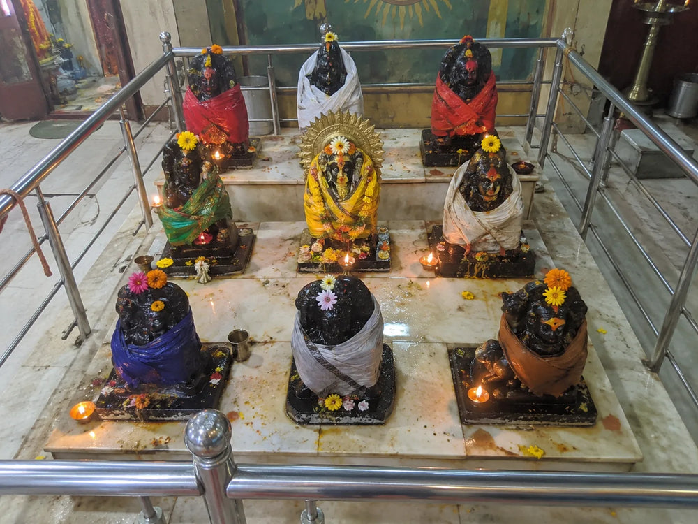 Navgraha Shanti Puja: the nine grahas on their platform, each dressed in its own colour