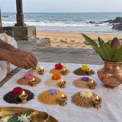 Nine heaps of grain with flowers and small lamps arranged for a Navgraha puja