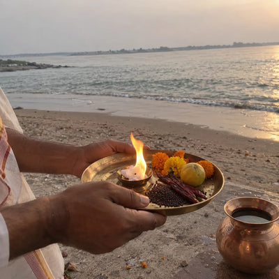 A camphor flame, red chillies, mustard seeds and a lemon on a brass plate