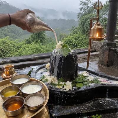 Panchamrut abhishek on a Shivling with misty Sahyadri hills behind