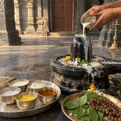 Panchamrut poured over a Shivling with five offering bowls and a rudraksha mala