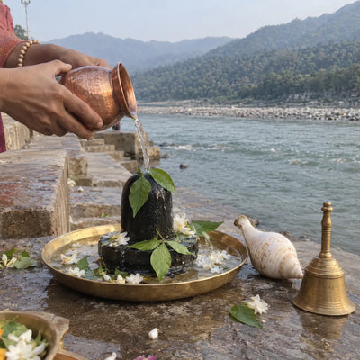 Gangajal abhishek on a Shivling on the ghat, with the Ganga behind