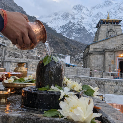 Rudrabhishek with Brahma Kamal flowers, snow peaks behind