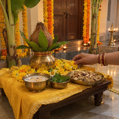 A yellow-draped chowki with a kalash, panchamrit and panjiri for Satyanarayan Katha