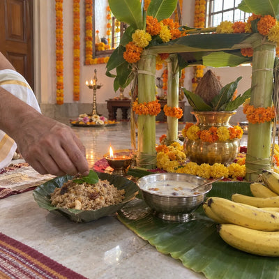 Satyanarayan puja set-up with a banana-stem mandap, kalash, panjiri and bananas