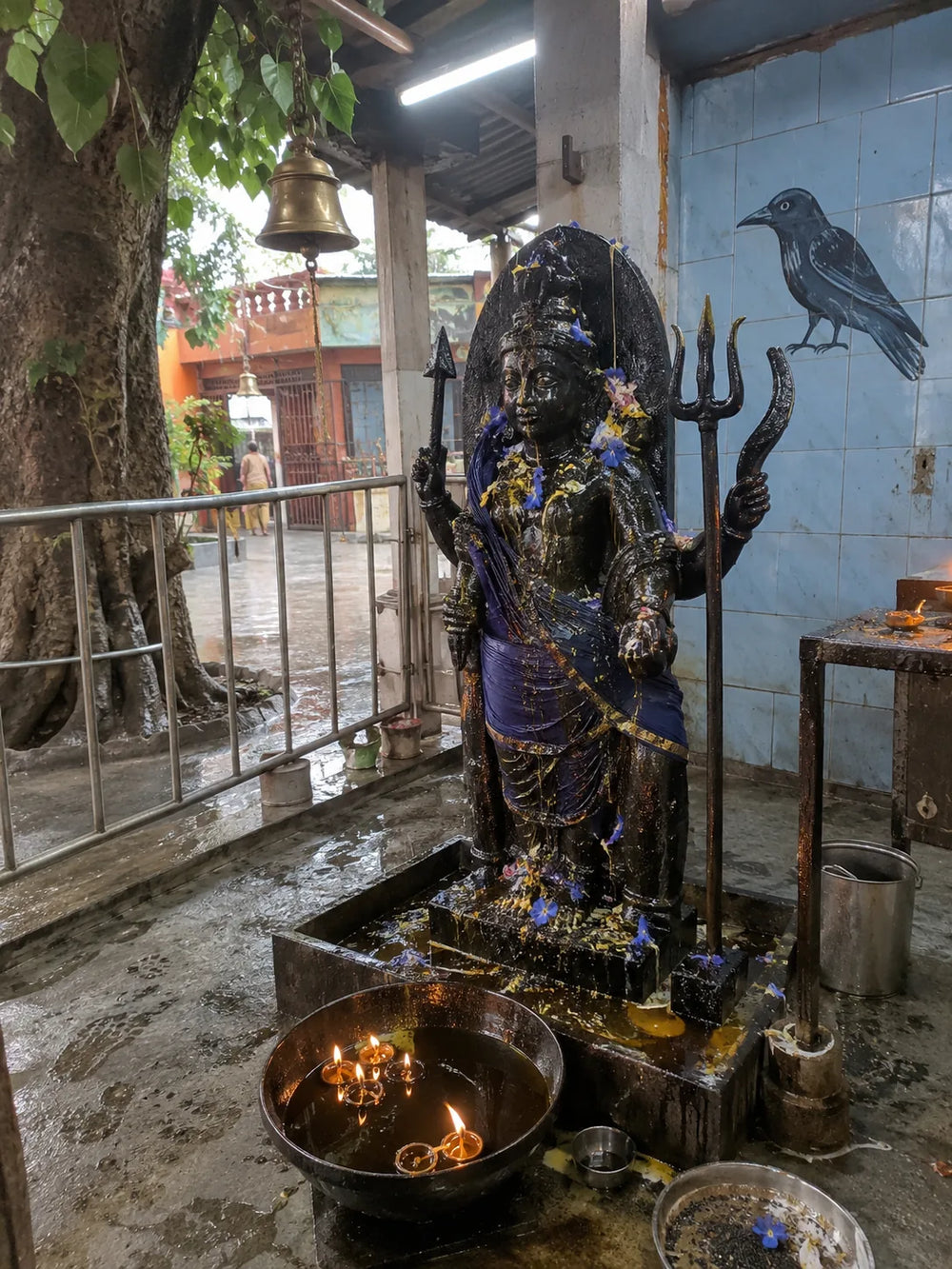 Shani Kavach Path: Shani Dev with his trident and crow, an oil lamp burning in front